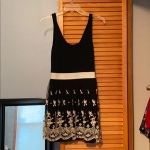 Small black dress with lace overlay on bottom